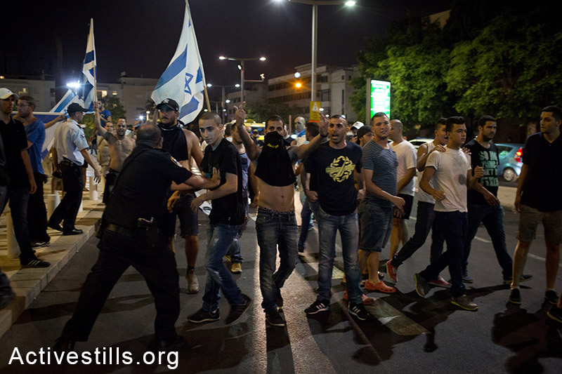Right-wing nationalists attacking left-wing activists during a protest in central Tel Aviv against the Israeli attack on Gaza, July 12, 2014. The protest ended with the nationalists attacking a small group of left-wing activists, with little police interference. Three activists were injured and one right-wing person was arrested. (Oren Ziv/Activestills.org)