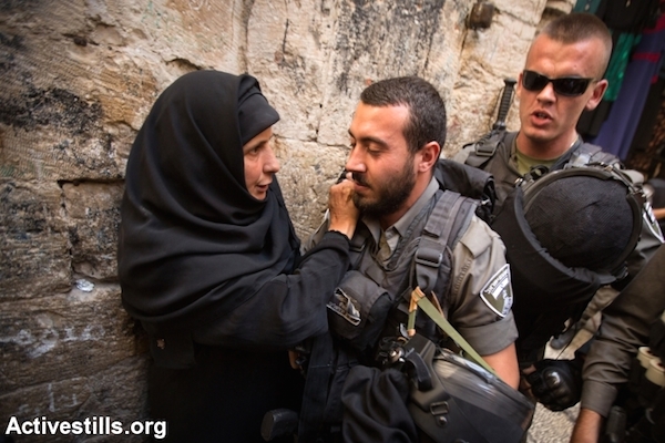 Israeli Border Police officers prevent worshippers from entering the Aqsa Mosque in Jerusalem, September 26, 2014. (Photo by Faiz Abu Rmeleh/Activestills.org)