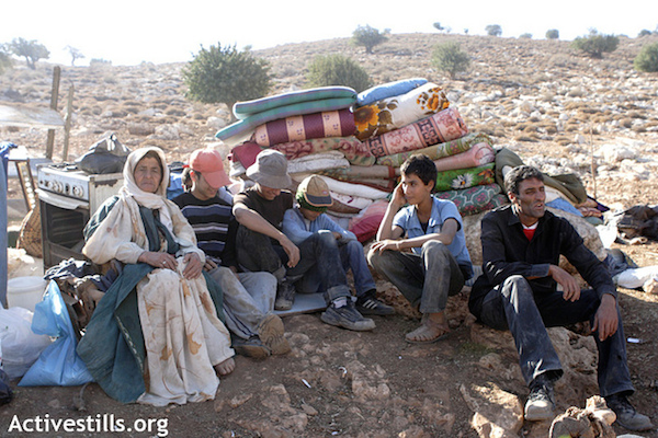 A Palestinian Bedouin family after their Jordan Valley home was demolished by Israeli army forces. (File photo by Anne Paq/Activestills.org)
