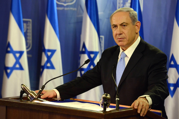 Prime Minister Benjamin Netanyahu speaking in front of Israeli flags, July 20, 2014. (Photo by Haim Zach / GPO)