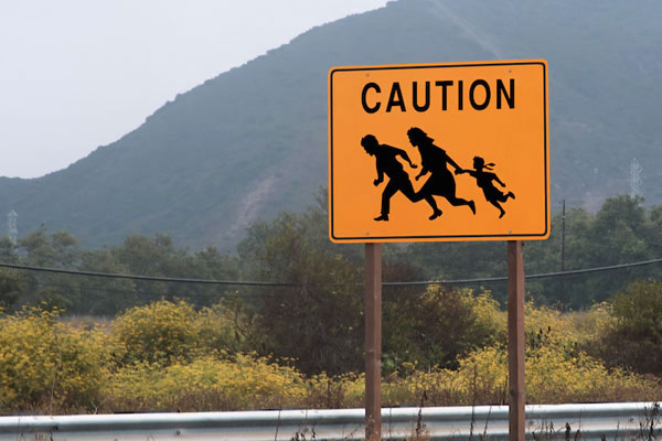 Sign warning of immigrants near the U.S.-Mexican Border. (Photo by Shutterstock.com)