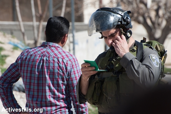 Israeli border police check the ID of a Palestinian man (File photo by Ryan Rodrick Beiler/Activestills.org)
