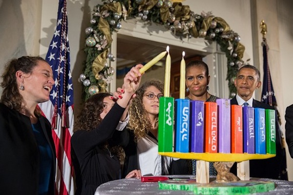 President Barack Obama, First Lady Michelle Obama, Rabbi Bradley Artson, and students from Hand in Hand participate in the Menorah lighting during Hanukkah reception #1 in the Grand Foyer of the White House, Dec. 17, 2014. (Official White House Photo by Pete Souza)
