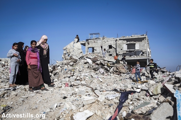 Relatives walk amidst the rubble of the home of Zaki Wahdan in the city of Beit Hanoun, northern Gaza City, November 10, 2014. Eight members of the Wahdan family, mostly women and children were killed. (Photo by Anne Paq/Activestills.org)