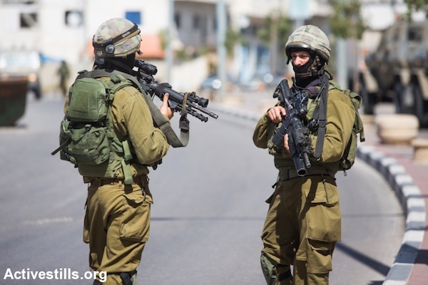 Illustrative photo of masked IDF soldiers. (Oren Ziv/Activestills.org)