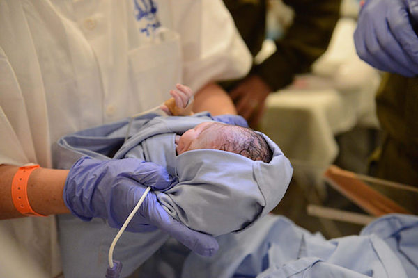 A baby is delivered at the Israeli army’s field hospital in Nepal, April 29, 2015. (Photo by IDF Spokesperson)