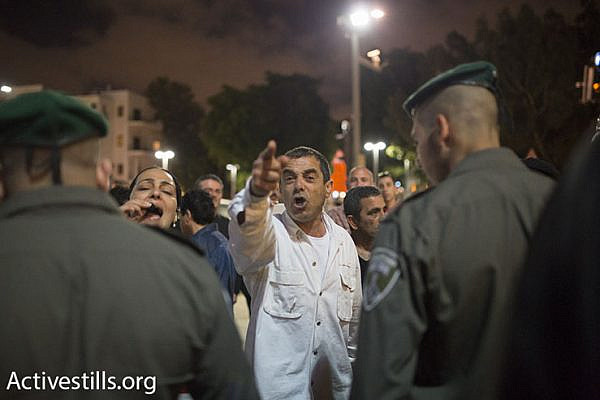 Opposite a pro-refugee rally, residents of south Tel Aviv protest the presence of African asylum seekers in their community, Tel Aviv, May 2, 2015. (Photo by Oren Ziv/Activestills.org)
