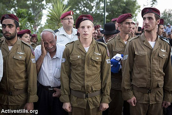 Soldiers and relatives mourn at the grave of Israeli Sergeant Banaya Rubel during his funeral on July 20, 2014 in Holon, Israel. (Oren Ziv/Activestills.org)