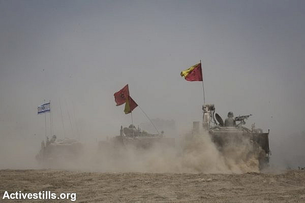 Merkava tanks and APC's maneuver near the border between Israel and the Gaza Strip, August 5, 2014. (Oren Ziv/Activestills.org)