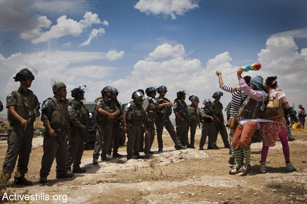 Members of the ‘Clown Army’ confront Israeli security forces during a solidarity protest in the Palestinian village of Susya, June 22, 2012. (Photo by Oren Ziv/Activestills.org)