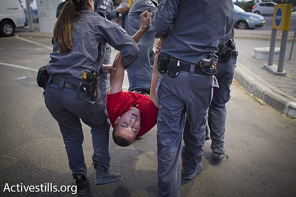 Israeli police arrests a Palestinian protester at a demonstration for the release of hunger striker Mohammad Allan, outside of Barzilai hospital in Ashkelon, Israel. (Oren Ziv/Activestills.org)