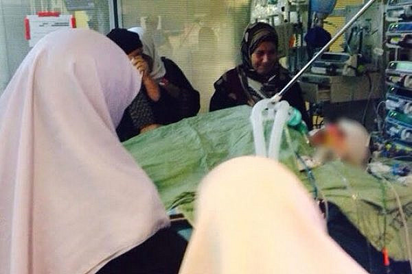 Women of the Dawabsha family sit around Reham’s hospital bed, September 5, 2015. (Photo: Samah Salaime)