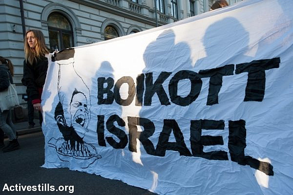 Activists hold a banner reading "Boycott Israel" during a protest in solidarity with Palestine near the Israeli embassy in Oslo, Norway, October 17, 2015. The protest was part of a global wave of demonstrations in solidarity with Palestine. (photo: Ryan Rodrick Beiler/Activestills.org)