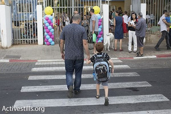 Illustrative photo of a parent bringing his child to school in Jaffa, Israel. (Oren Ziv/Activestills.org)
