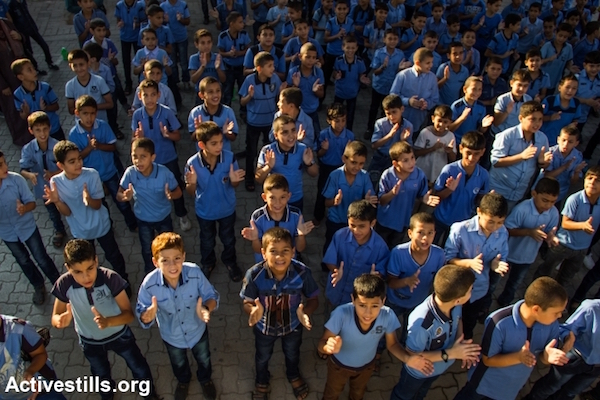 Palestinian boys line up during a morning assembly at a UNRWA school in Gaza City, Gaza Strip, September 15, 2014. (Anne Paq/Activestills.org)