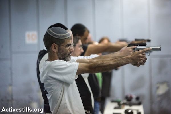 Illustrative photo of Israelis taking a shooting class in a Jerusalem gun shop, October 15, 2015. A number of Israeli leaders have called on citizens to arm themselves in response to a wave of Palestinian stabbing attacks, and the owner of this shop reported an increase in demand for personal weapons. (Yotam Ronen/Activestills.org)