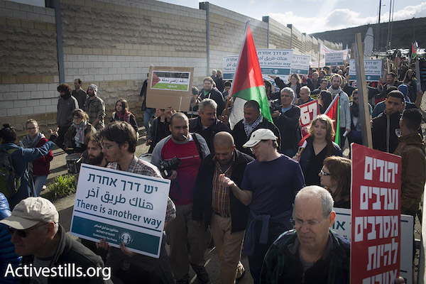 Jewish Israelis and Palestinians march along the major Hebron-Jerusalem highway in the southern West Bank demanding an end to the occupation, Beit Jala, West Bank, January 15, 2016. (Oren Ziv/Activestills.org)