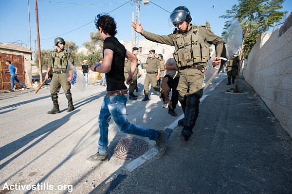 Palestinian Authority police attempt to prevent youth in Aida Refugee Camp from clashing with Israeli forces, Bethlehem, West Bank, September 27, 2013. (Ryan Rodrick Beiler/Activestills.org)