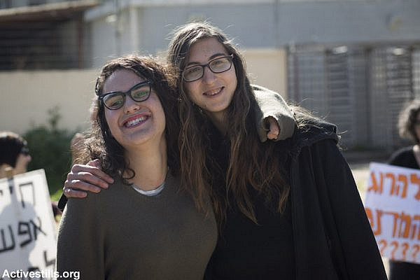 Young Israeli women Tair Kaminer and Tania Golan pose for a final photo outside the Tel Hashomer induction base where they announced their refusal to serve in the Israeli army, January 31, 2016. Kaminer was sentenced to prison.