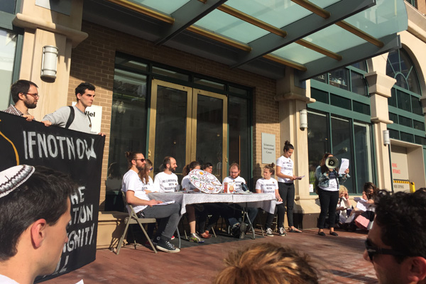 Members of IfNotNow hold a Liberation Seder in front of Hillel’s headquarters in Washington D.C., April 19, 2016. (Courtesy photo)