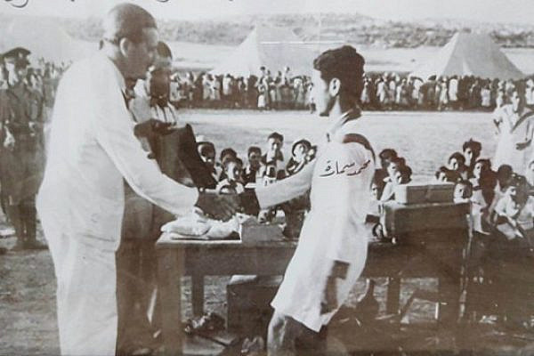 My grandfather, Mohammed Samara, shaking hands with an official at a football tournament in Jerusalem during the British mandate of Palestine, 1946. Photo courtesy of the Samara family.