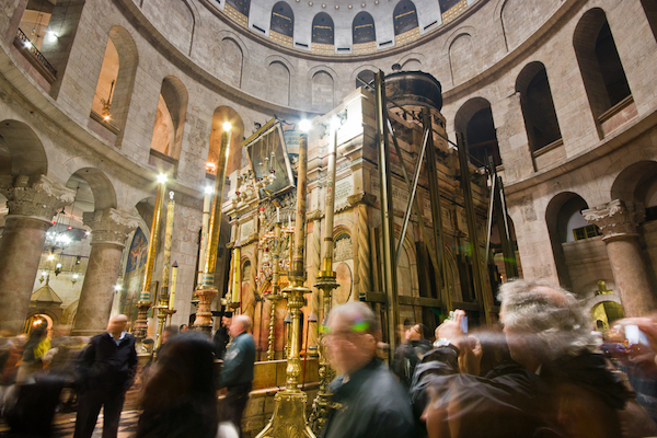 Tourists and worshipers visit the Church of the Holy Sepulcher in the Old City of Jerusalem. (Photo by Fat Jackey / Shutterstock.com)