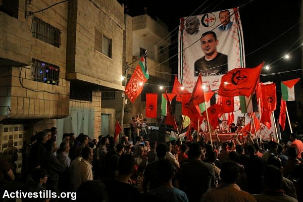 Palestinians take part in a protest in solidarity with the Palestinian prisoner Bilal Khaled, in the village of Asira Ash Shamaliya, Nablus district, West Bank, June 18, 2016.