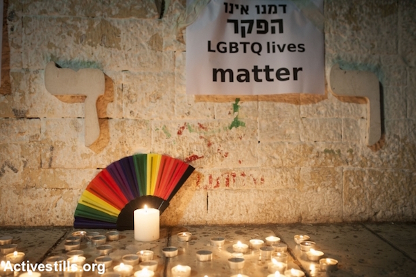 Israeli LGBTQ activists take part in a vigil in solidarity with the victims of the Orlando massacre, in centre Tel Aviv, June 12, 2016. (Oren Ziv/Activestills.org)