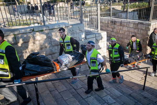 Zaka rescue personnel carry the bodies of Palestinian attackers at the scene of a shooting and stabbing attack near Damascus Gate, Jerusalem, February 3, 2016. Three Israelis were wounded, two critically and one lightly, after being stabbed by three Palestinian attackers, who were shot and killed by Israeli security forces at the scene. Photo by Yonatan Sindel/Flash90)