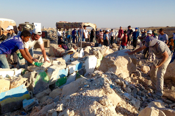 Jewish activists work with the Palestinian residents of Umm el-Kheir to rebuild structures demolished by Israeli military authorities, South Hebron Hills, West Bank, September 10, 2016. (Sarah Stern)