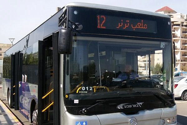 A Dan bus in Be'er Sheva, which includes station names in both Hebrew and Arabic.
