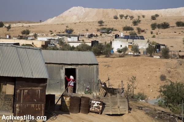 A Bedouin woman enters a tin shack in the unrecognized village of Umm el-Hiran, the Negev. November 22, 2016. Residents expected Israeli authorities to demolish the entire village a few hours earlier. (Keren Manor/Activestills.org)