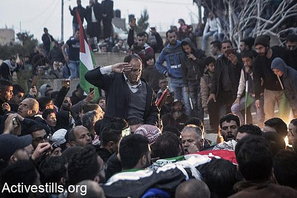 The father of Basel al-Araj says a last goodbye to his son as he is buried, Al Walaja, West Bank, March 16, 2017. (Activestills.org)
