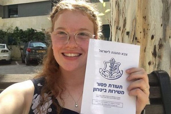 Conscientious objector Tamar Alon holds up her release papers after spending 130 days in military prison. (Courtesy of Mesarvot)
