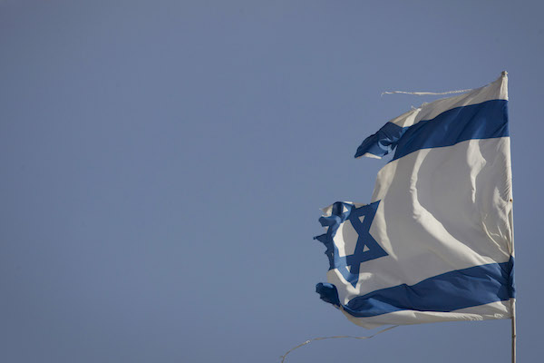 A torn Israeli flag seen at the settlement of Gevaot, September 2, 2014. (Miriam Alster/FLASH90)