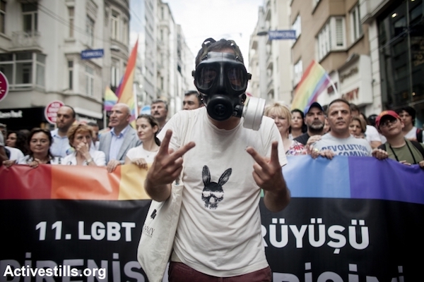 An activist wearing a gas mask, during Turkey's Pride Parade held in Istanbul, June 30, 2013. The parade held more the 30,000 participants. (Shiraz Grinbaum/Activestills.org)