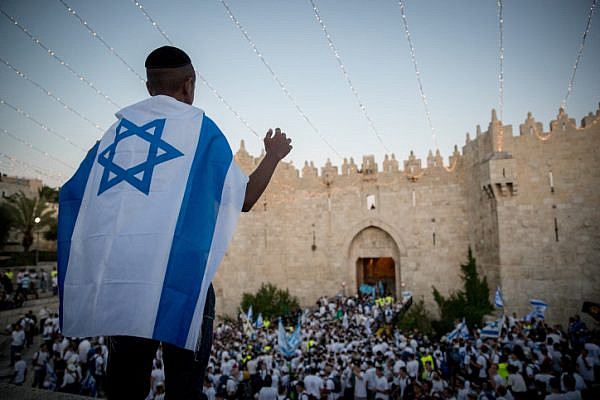 Thousands of Israeli Jews wave flags as they mark Jerusalem Day in Damascus Gate on their way to the Western Wall, East Jerusalem, May 24, 2017. (Yonatan Sindel/Flash90)
