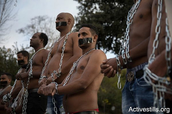 Eritrean asylum seekers stage a mock slave auction outside the Knesset to protest Israel's plans to deport tens of thousands of Sudanese and Eritrean asylum seekers, January 17, 2018, Jerusalem. (Oren Ziv/Activestills.org)