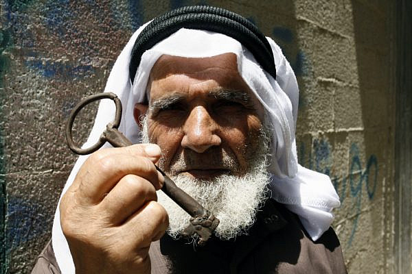 A Palestinian refugee, Saleh Saleh Abu Rass, holds up a key from his original home in Be'er Sheva, located in southern Israel, during a rally, in Rafah refugee camp, southern Gaza Strip, May 12, 2013. (Abed Rahim Khatib/Flash 90)