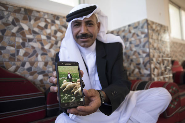 Salah holds a picture of himself herding sheep. al-Jabal, June 12, 2018. (Oren Ziv / Activestills.org)