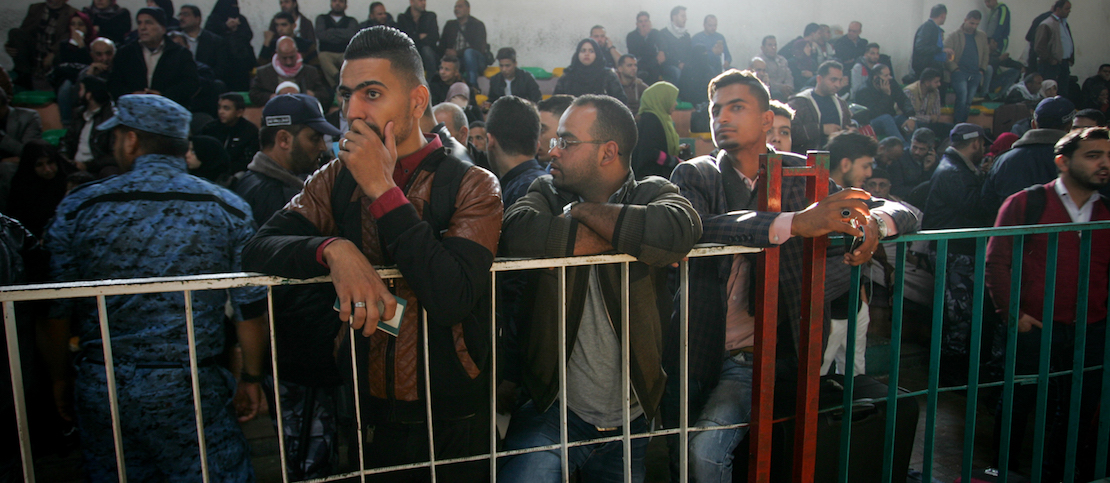 Palestinians wait for travel permits to cross into Egypt, for the first time since the Palestinian reconciliation deal, in the southern Gaza Strip on November 18, 2017. (Abed Rahim Khatib/Flash90)