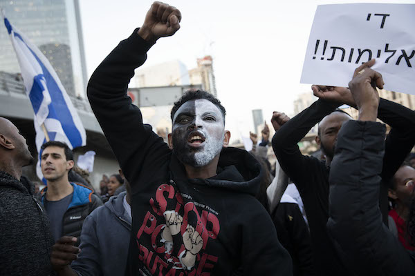 Thousands of Ethiopian Israelis and their supporters marched against police violence in Tel Aviv on Jan. 30, 2018, weeks following the fatal police shooting of Yehuda Biadga. (Oren Ziv/Activestills.org)