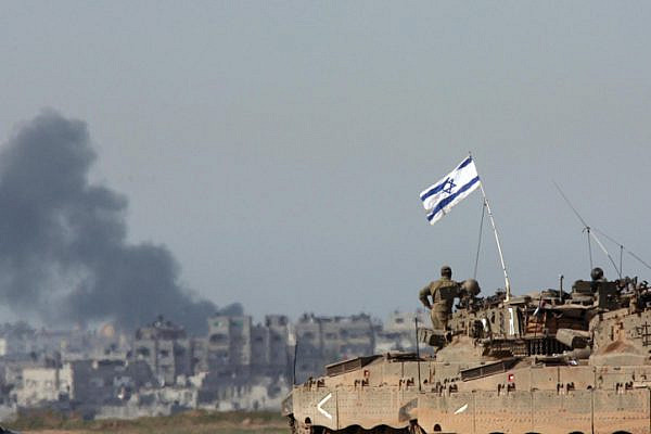 Israeli tanks standing on the Israel-Gaza border while smoke billows from Gaza during Operation Cast Lead, January 14, 2009. (Yossi Zamir/Flash90)