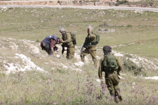 Israeli soldiers seen attacking and throwing stones at photographers in the Palestinian village of Nabi Saleh, April 24, 2015.