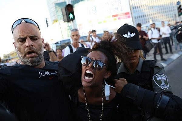 Israeli police officers arrest an Ethiopian Israeli demonstrator during a protest against police brutality and racism in central Tel Aviv, July 3, 2019. (Oren Ziv/Activestills.org)
