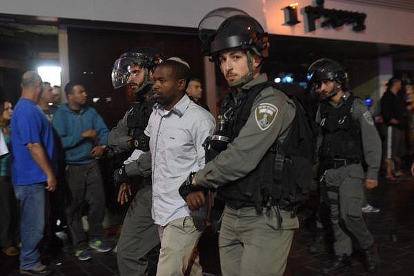 Police arrest a demonstrator taking part a protest attended by thousands of Israeli-Ethiopians against police violence and racism, Tel Aviv. May 3, 2015. (Ben Kelmer/Flash90)