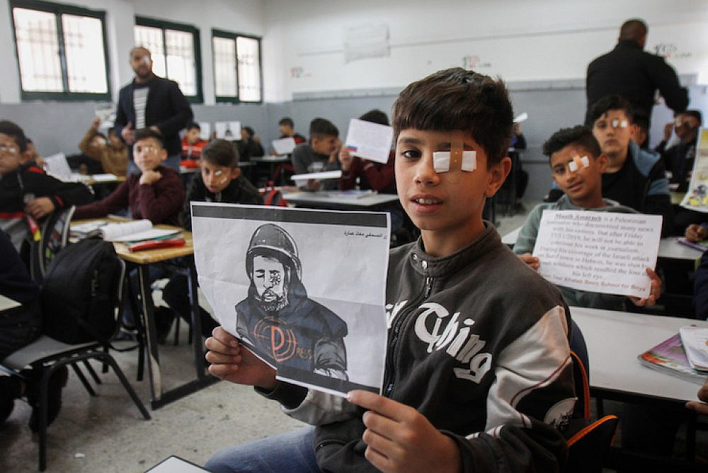 Palestinian students at Salem School in Nablus, West Bank wear eye patches in solidarity with journalist Moath Amarnih, who was wounded and lost sight in one eye during clashes with the Israeli army in the village of Surif. November 18, 2019. (Nasser Ishtayeh/Flash90)