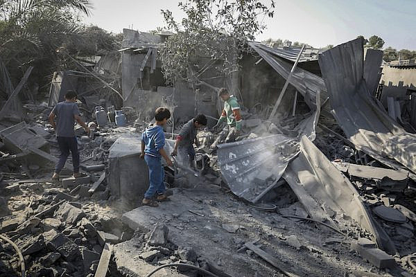 Palestinians survey the destruction following an Israeli air strike, in Khan Younis in the southern Gaza Strip, November 14, 2019.  (Abed Rahim Khatib/Flash90)