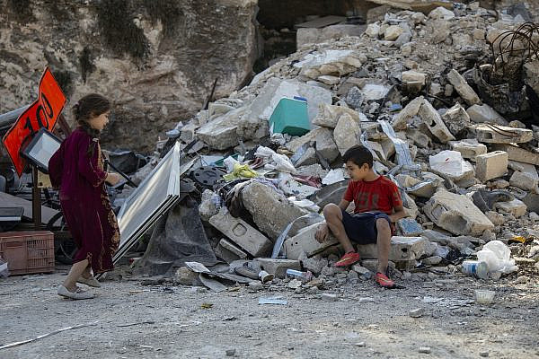 Quosiy Burqan's children in front of the ruins of their home after it was demolished by Israeli authorities, Silwan, East Jerusalem, November 8, 2019. (Faiz Abu Rmeleh/Activestills.org)