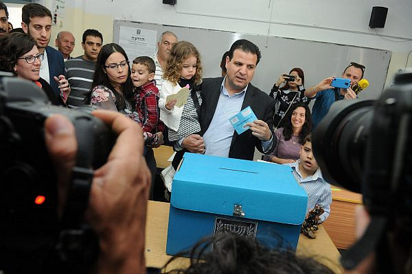 Leader of the Joint List, Ayman Odeh, casts his vote at a ballot station in Nazareth on election day for the 20th Knesset, March 17, 2015. (Basal Awidat/Flash90)